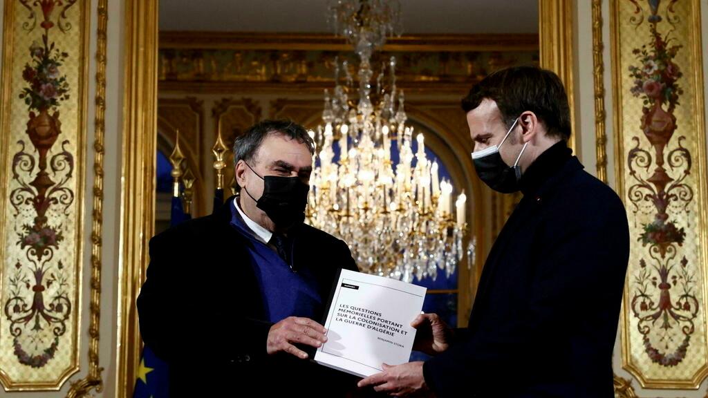 French President Emmanuel Macron, right, meets historian Benjamin Stora as he receives the report on the memory of the colonisation and the Algerian war at the Elysee Palace in Paris, Wednesday, Jan. 20, 2021. French President Emmanuel Macron wants to take further steps to reckon with France&rsquo;s colonial-era wrongs in Algeria but is not considering an official apology, his office said. (Christian Hartmann/Pool via AP)