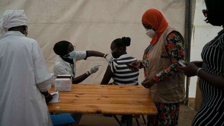 FILE- In this Wednesday, July 28, 2021 file photo, A health worker administers a dose of Janssen COVID-19 vaccine at Leopold Sedar Senghor stadium in Dakar, Senegal. Thousands of new coronavirus cases have been reported in West Africa in recent weeks amid low vaccination rates and the spread of the delta variant. (AP Photo/Leo Correa, File)