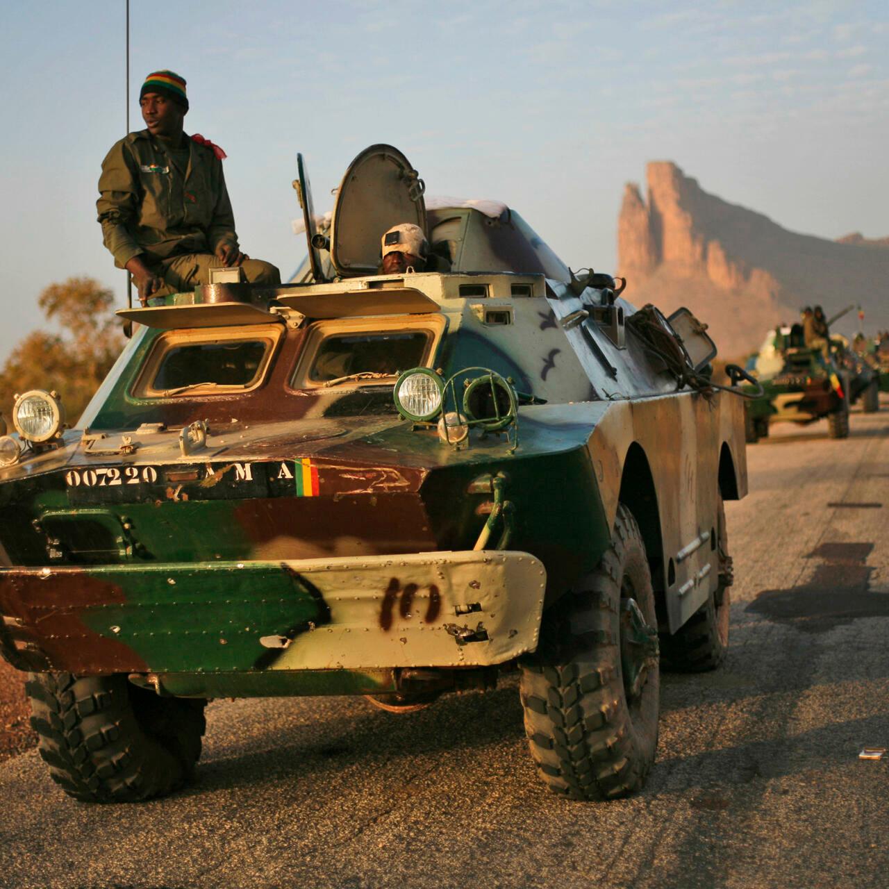 A convoy of Malian troops makes a stop to test some of their weapons near Hambori, northern Mali, on the road to Gao, Monday Feb. 4, 2013. French troops launched airstrikes on Islamic militant training camps and arms depots around Kidal and Tessalit in Mali&rsquo;s far north, defense officials said Sunday, as the first supply convoy of food, fuel and parts to eastern Mali headed across the country.(AP Photo/Jerome Delay)