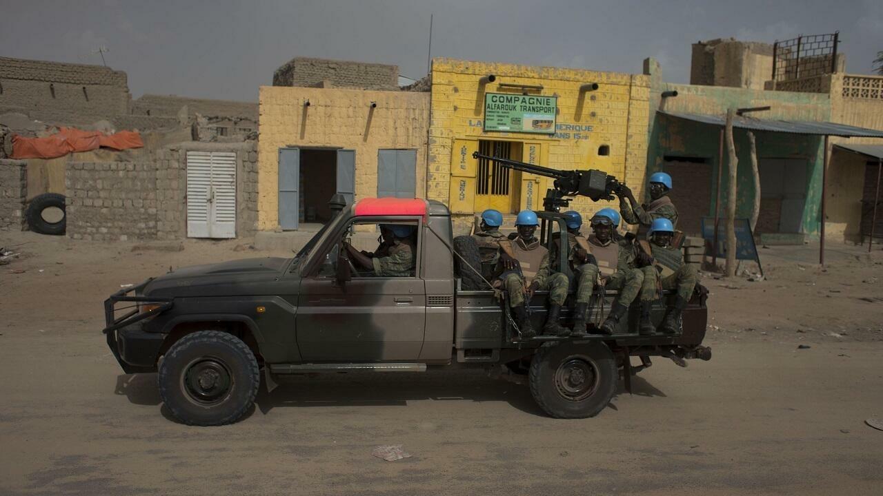 United Nations peacekeepers from Burkina Faso patrol along a main street in Timbuktu, Mali, July 23, 2013. Mali&rsquo;s presidential election is set to go ahead on Sunday despite massive logistical and technical lapses, including a voters&rsquo; roll which inexplicably is missing the names of tens of thousands of registered voters. (AP Photo/Rebecca Blackwell)