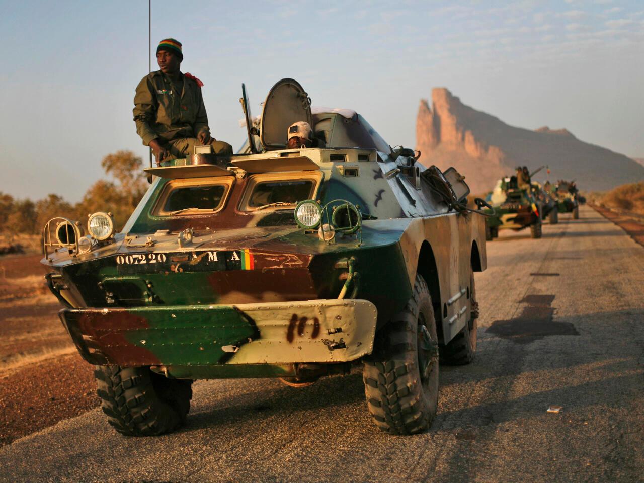 A convoy of Malian troops makes a stop to test some of their weapons near Hambori, northern Mali, on the road to Gao, Monday Feb. 4, 2013. French troops launched airstrikes on Islamic militant training camps and arms depots around Kidal and Tessalit in Mali&rsquo;s far north, defense officials said Sunday, as the first supply convoy of food, fuel and parts to eastern Mali headed across the country.(AP Photo/Jerome Delay)