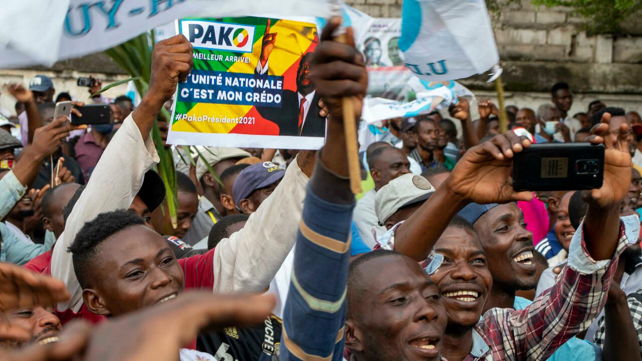 FILE – In this Friday March 19, 2021 file photo, supporters of opposition presidential candidate Guy Brice Parfait Kolelas cheer during their party’s last rally of the presidential campaign in Brazzaville, Congo. Republic of Congo pressed ahead Sunday March 21, 2021 with an election in which President Denis Sassou N’Guesso is widely expected to extend his 36 years in power, while the leading opposition candidate was flown to France after suffering COVID-19 complications. (AP Photo/Christ Kimvidi, File)