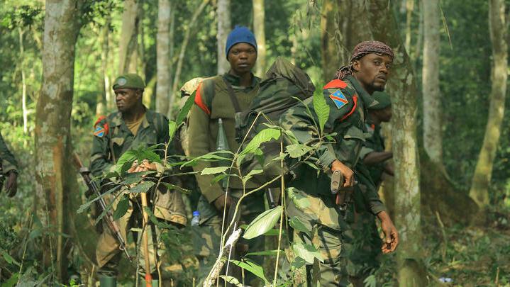 FARDC (Armed Forces of the Democratic Republic of Congo) soldiers patrol near Semuliki in the Virunga National Park on December 14, 2021. – On December 14, 2021, the Ugandan army announced that it had shelled three Allied Democratic Forces (ADF) rebel bases. On November 30, 2021 the UPDF, with the agreement of the Congolese authorities, had bombed ADF positions in Virunga National Park before Ugandan ground forces entered Congolese territory. The ADF are accused by Kampala of being responsible for recent attacks on Ugandan soil claimed by the jihadist organisation Islamic State (EI), which presents the group as its province in Central Africa (Iscap). (Photo by Sébastien KITSA MUSAYI / AFP)