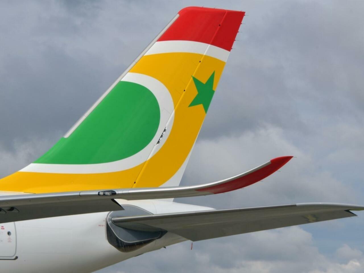 This illustration picture taken on November 15, 2019 shows the tail of an Air Senegal Airbus A330-900 aircraft parked on the tarmac of the Airbus delivery center in Colomiers, southwestern France. (Photo by PASCAL PAVANI / AFP)