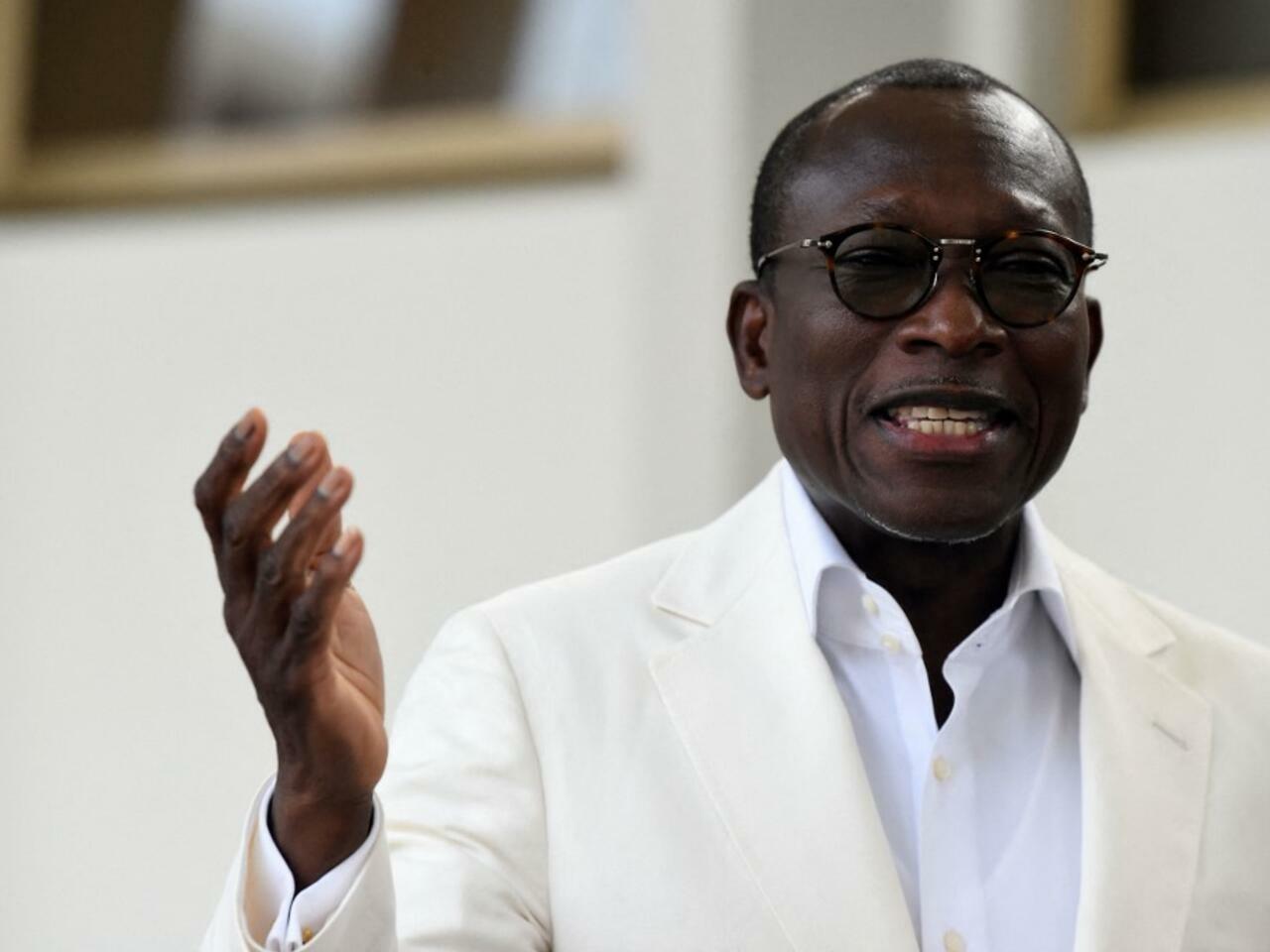 Beninoise President Patrice Talon speaks during the inauguration of a symbolic exhibition to showcase artefacts looted by the French colonial soldiers returned to the country at the presidency in Cotonou on February 19, 2022. – Twenty-six artefacts seized by French colonial soldiers from the Abomey Kingdom in 1892 returned to Benin has been exhibited in Benin’s capital Cotonou, and will be open tomorrow for viewing by the general public. (Photo by PIUS UTOMI EKPEI / AFP)