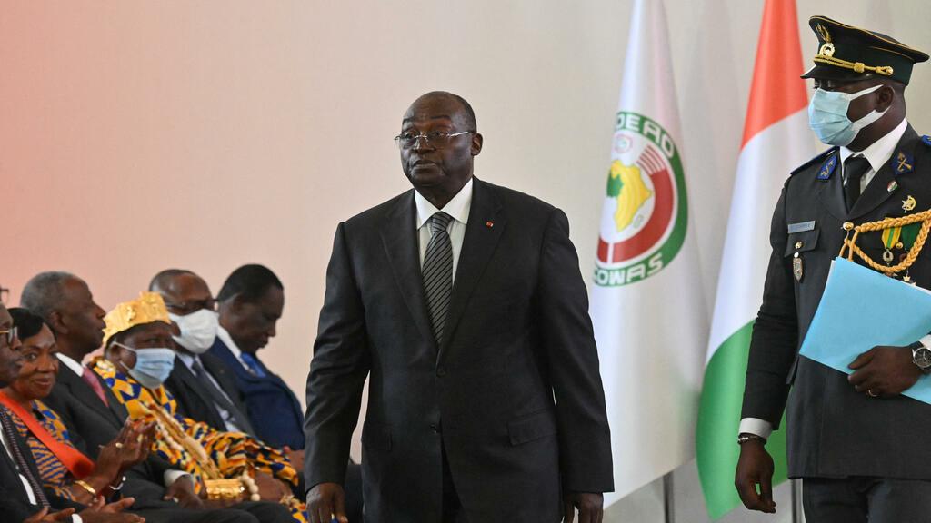 Ivorian vice president Tiemoko Meyliet Kone (2nd R) walks after being sworn in at the presidential palace in Abidjan on April 20, 2022, a day after his appointment to this post that had been vacant for nearly two years. (Photo by Issouf SANOGO / AFP)