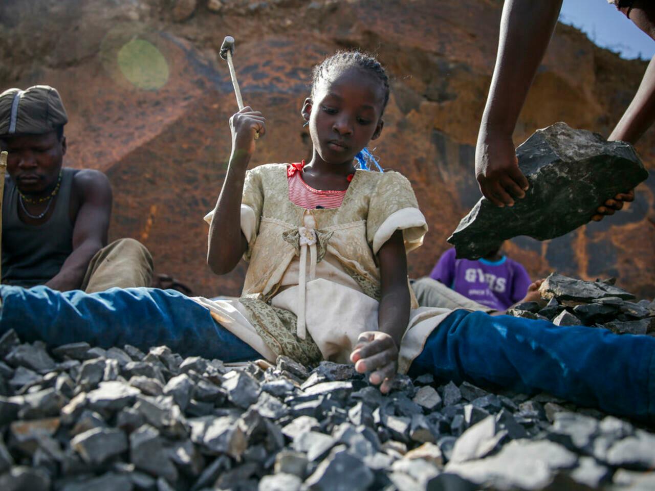 Irene Wanzila, 10, breaks rocks with a hammer at the Kayole quarry in Nairobi, Kenya Tuesday, Sept. 29, 2020, as she works along with her younger brother, older sister and mother, who says she was left without a choice after she lost her cleaning job at a private school when coronavirus pandemic restrictions were imposed. The United Nations says the COVID-19 pandemic risks significantly reducing gains made in the fight against child labor, putting millions of children at risk of being forced into exploitative and hazardous jobs, and school closures could exacerbate the problem. (AP Photo/Brian Inganga)