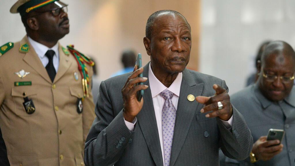 (FILES) In this file photograph taken on February 10, 2020, Guinea’s President Alpha Conde (C), gestures as he arrives at The African Union Headquarters in Addis Ababa, during the 33rd Ordinary Session of the Assembly of the African heads of States. – Guinea’s ruling party on August 31 confirmed months of speculation that President Alpha Conde will seek a third term in office, a possibility that had already sparked deadly mass protests. The news came after the 82-year-old president pushed through a constitutional reform in March that critics had already argued was a ploy to allow him to run for office again in the October 18 election. (Photo by Michael TEWELDE / AFP)