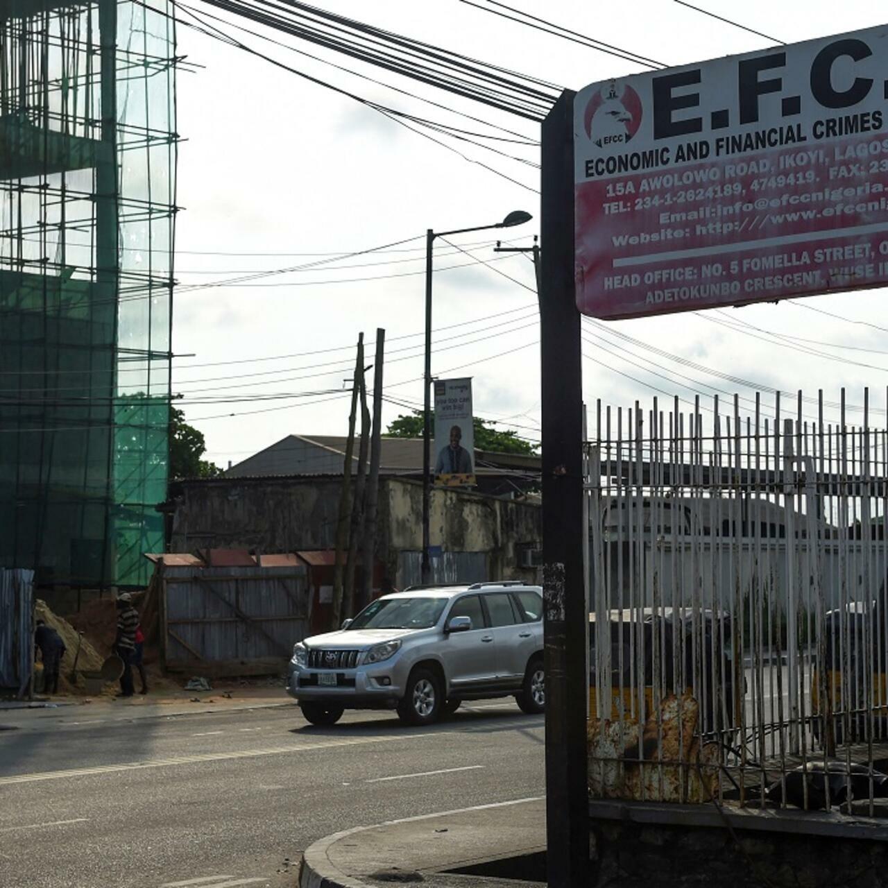 A motorcycle taxi drives past the sign of the Economic and Financial Crimes Commission (EFCC) in Lagos, on October 3, 2016. – A Nigerian court has convicted four firms allegedly used by a former aide of ex-president Goodluck Jonathan to launder $15.5 million in suspected stolen funds. The Economic and Financial Crimes Commission (EFCC) had in July frozen the accounts of the companies and seized $15.5 million (14 million euros) while investigating Waripamo-Owei Dudafa, Jonathan’s former domestic assistant, over money laundering. (Photo by PIUS UTOMI EKPEI / AFP)
