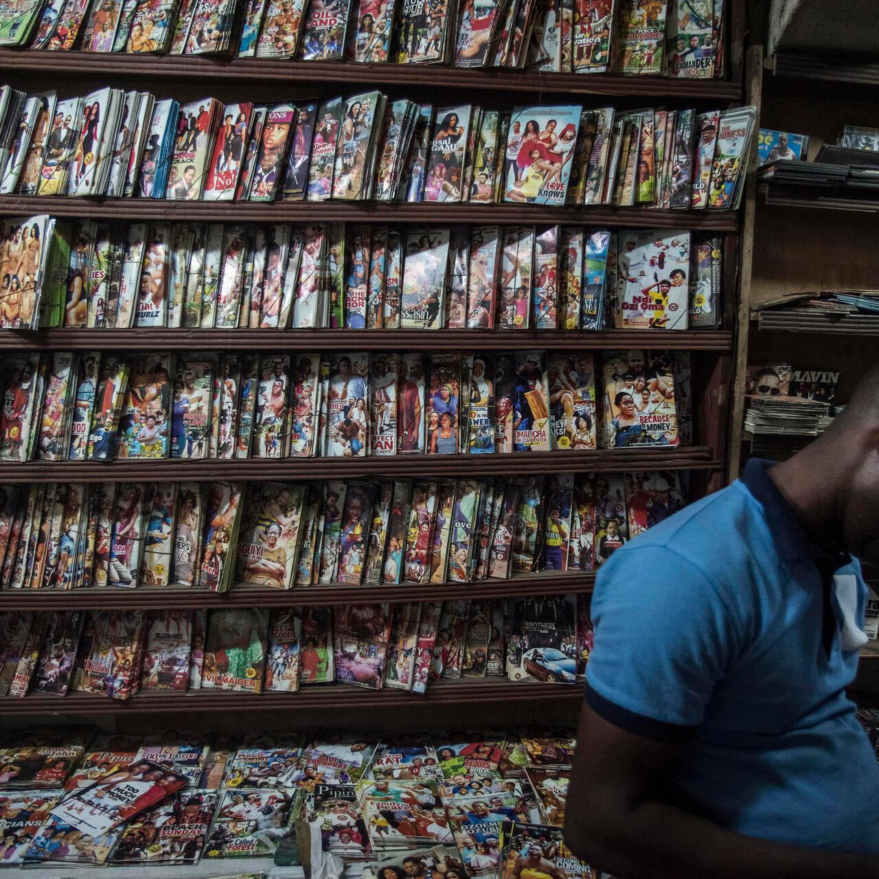 A man stands in front of a shelf full of Nollywood movies in a shop at Idumota market on February 19, 2019. Nigeria prepares to cast its vote next Saturday, February 23, after Independent National Electoral Commission (INEC) delayed the election day one week.
