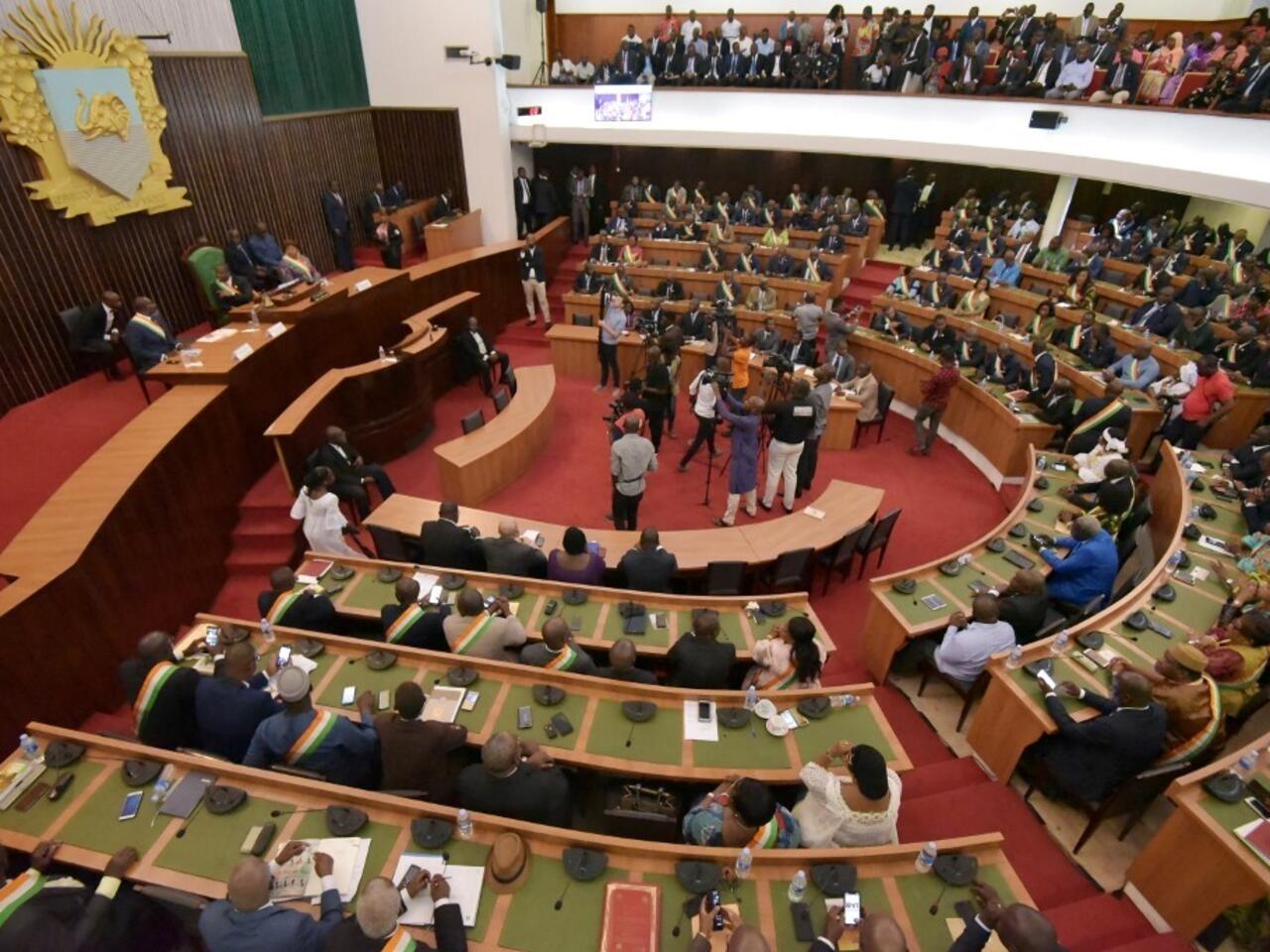 Ivorian lawmakers attend a special session of parliament in Abidjan, on February 8, 2019, during which Guillaume Soro announced he was stepping down as head of the National Assembly. – Soro resigned amid rumours he may be harbouring his own presidential ambitions in the 2020 elections. (Photo by Sia KAMBOU / AFP)