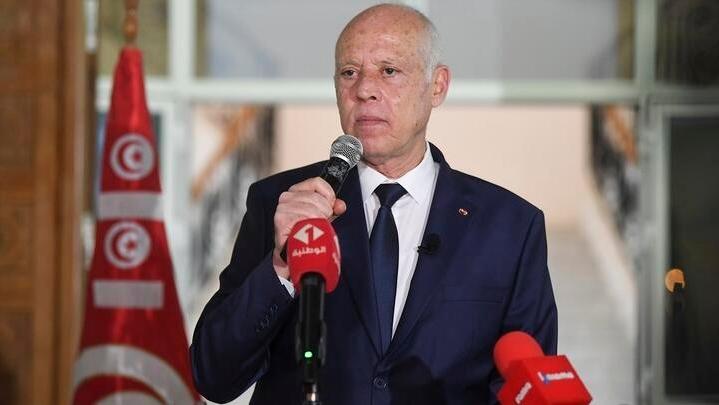 Tunisian President Kais Saied waves to Tunisian citizens as he delivers a speech during his visit to Sidi Bouzid, Tunisia, Monday, Sept. 20, 2021. Tunisia’s president has announced plans to draft a new electoral code and appoint a transitional leadership and to hang on to the exceptional powers that he seized in July, throwing the country’s young democracy into question. (Slim Abid/Tunisian Presidency via AP)
