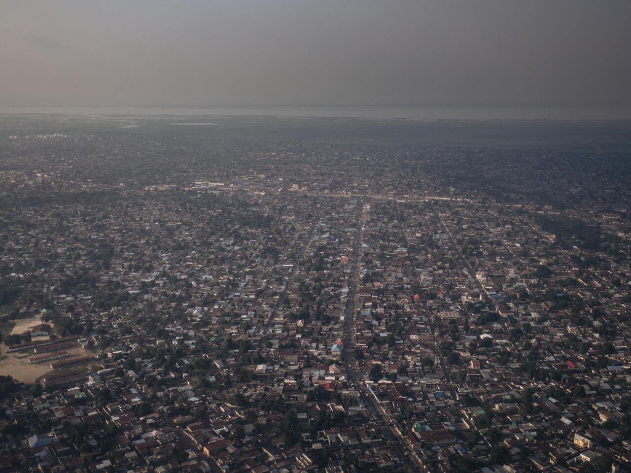 This photograph, taken on February 8, 2021 shows an aerial view of Kinshasa at sunset, capital city of the Democratic Republic of Congo. (Photo by ALEXIS HUGUET / AFP)