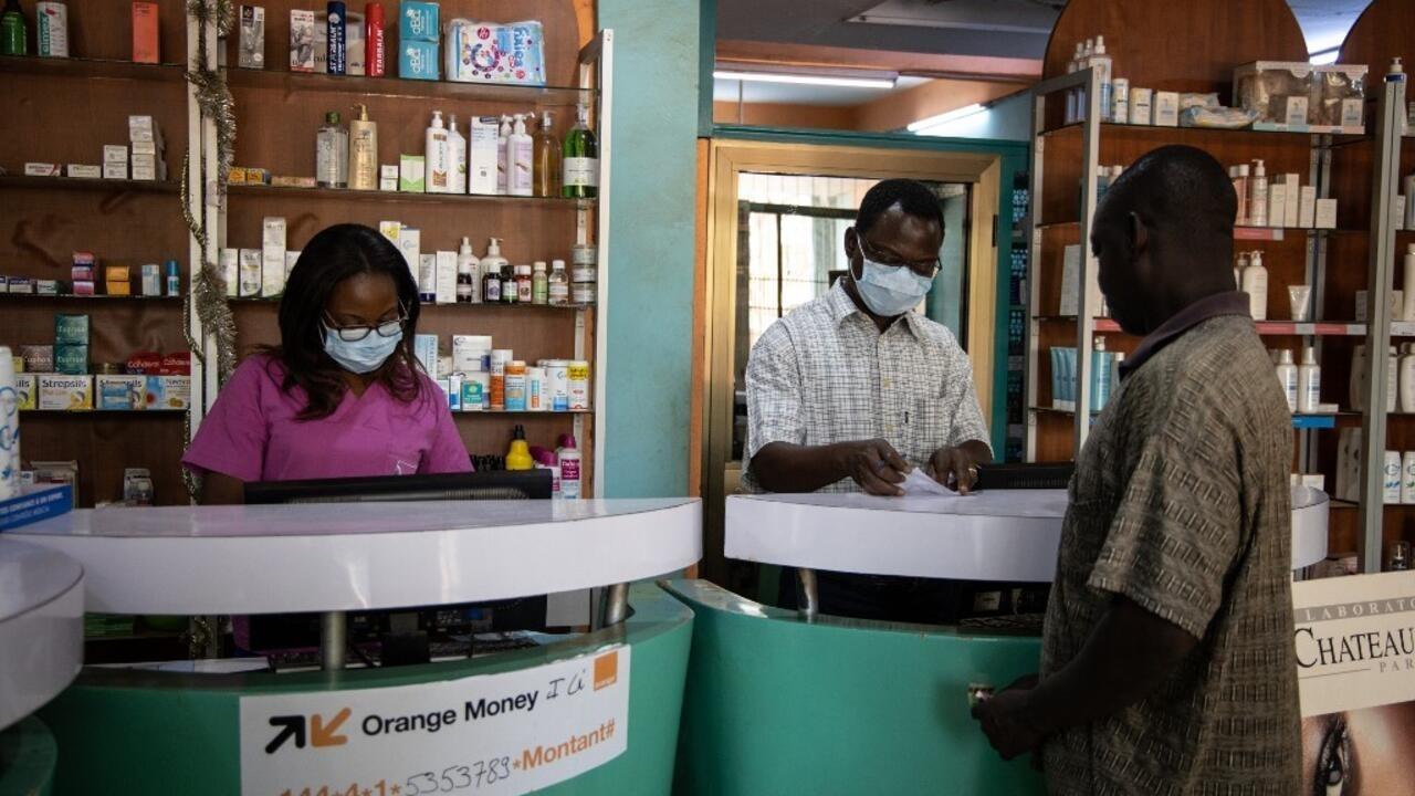 Pharmacy workers wear face masks as a preventive measure against the spread of the new COVID-19 coronavirus in Ouagadougou, on March 16, 2020. – The Burkina Faso government announced the closure of schools and universities until March 31, 2020, as a preventive measure against the COVID-19 coronavirus. The government also ordered the suspension of public and private demonstrations and rallies until the end of April 2020. (Photo by OLYMPIA DE MAISMONT / AFP)